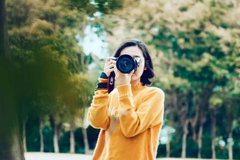 a woman holding a camera